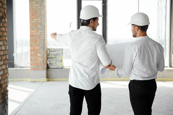 Two Engineers Assessing Building Interior